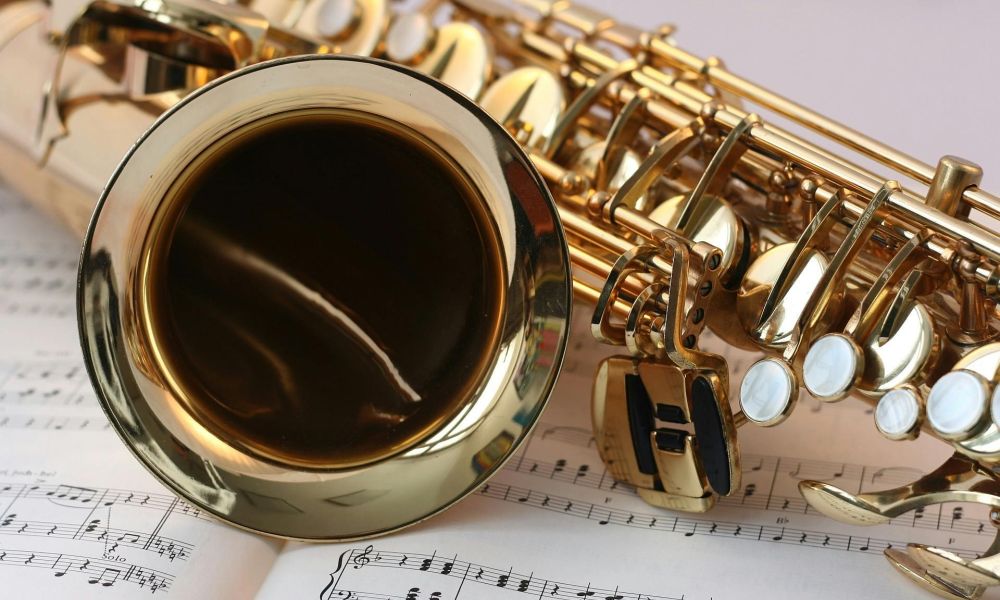 A stock photo of a brass instrument laying on a sheet of music