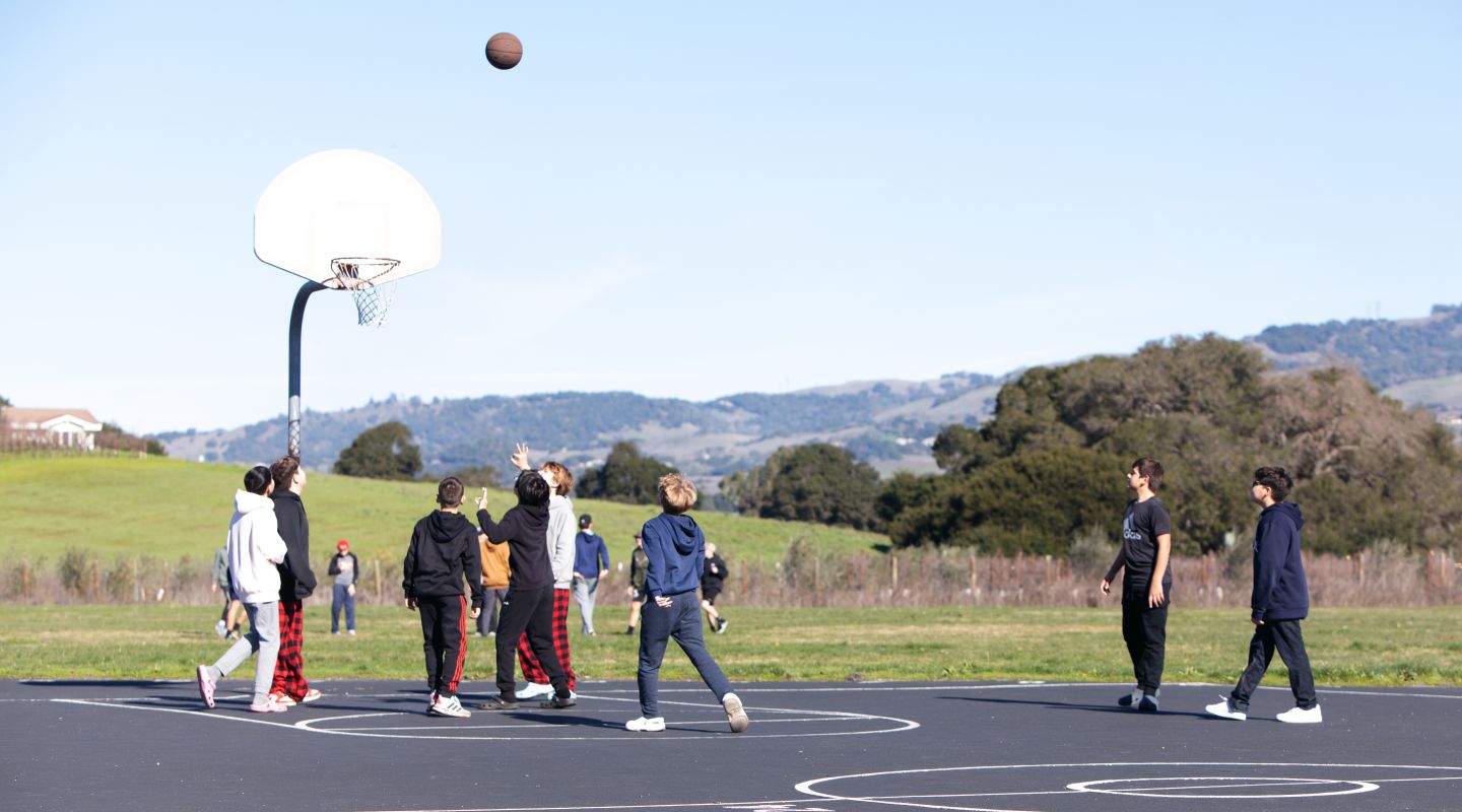 Kenilworth Junior High School students playing basketball outside