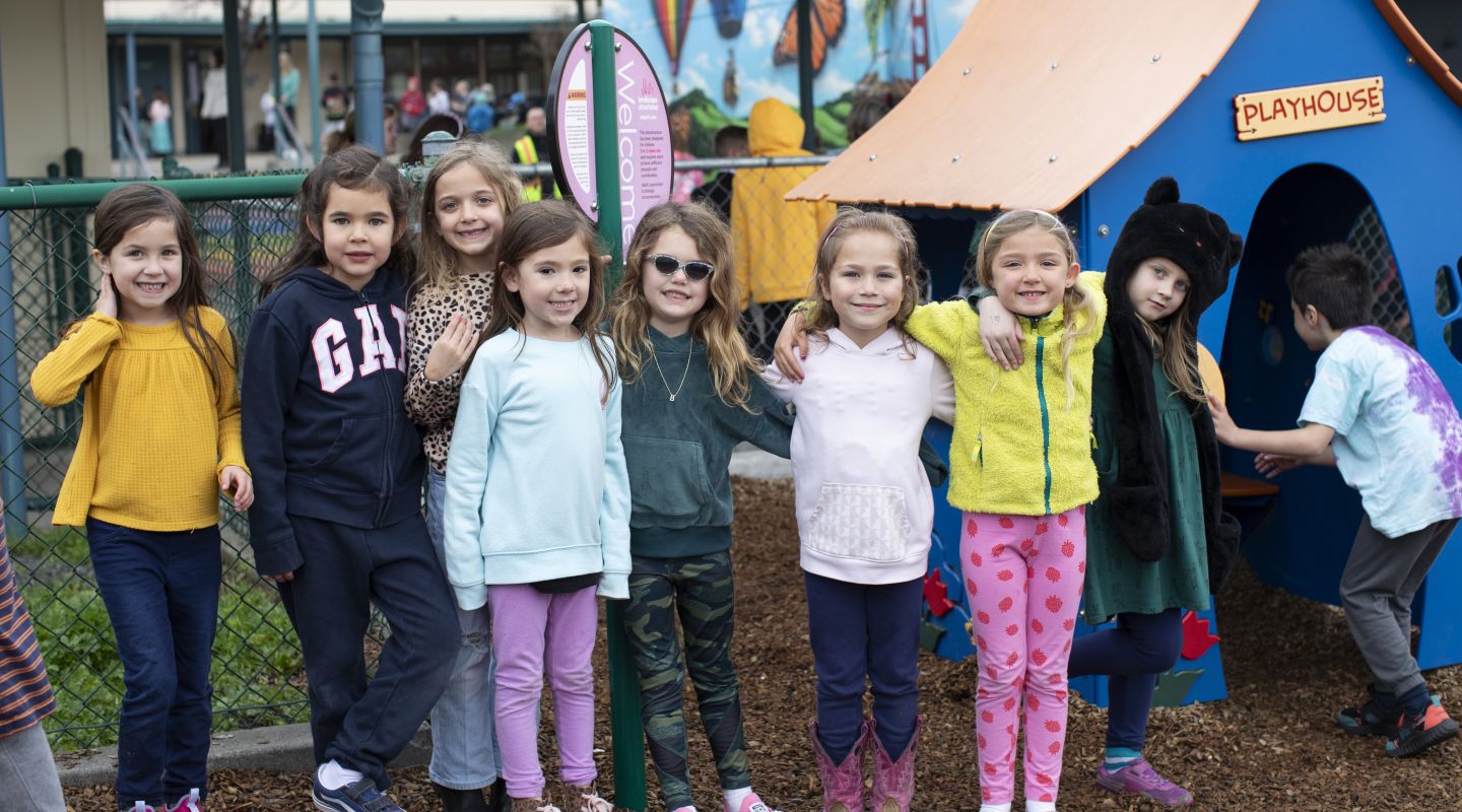 A group of Penngrove students with their arms around each other, smiling for the camera