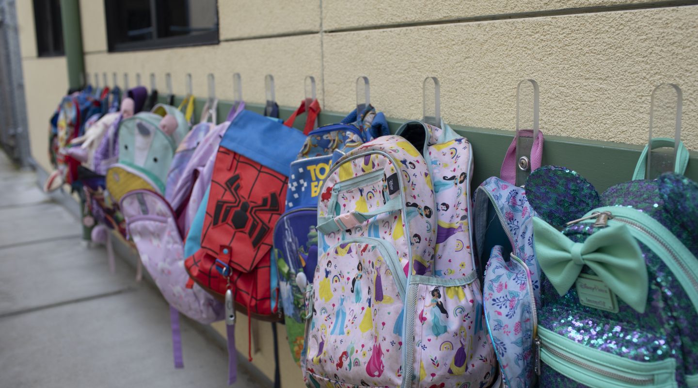 A line of backpacks hanging up outside on Penngrove Elementary School